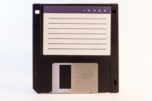 Detail of an old black floppy disk with space for tetx