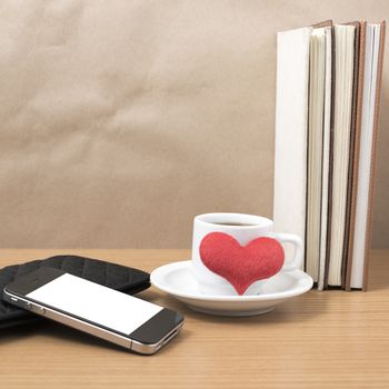 working table : coffee with phone,stack of book,wallet and heart on wood background