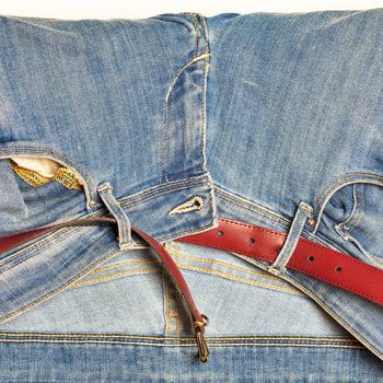 Leather red belt and women blue jeans