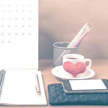 office desk : coffee with phone,wallet,calendar,heart,color pencil box,notepad,heart on wood background vintage style