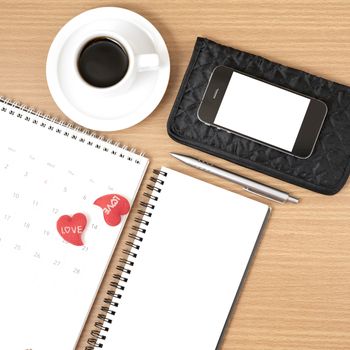 office desk : coffee with phone,wallet,calendar,heart,notepad on wood background