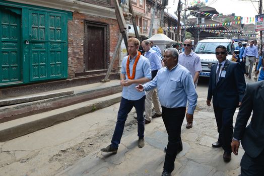 NEPAL, Kathmandu : Britain's Prince Harry walks with officials as he visits heritage sites in Patan Durbar Square on the outskirts of Kathmandu on March 20, 2016. Britain's Prince Harry arrived in Nepal for a five-day visit and said he hopes to shine a spotlight on resilience of Nepali people recovering from last year's devastating quake. 