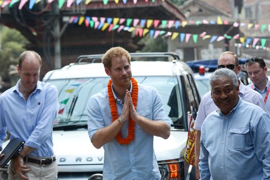 NEPAL, Kathmandu : Britain's Prince Harry gestures as he walks with officials as he visits heritage sites in Patan Durbar Square on the outskirts of Kathmandu on March 20, 2016. Britain's Prince Harry arrived in Nepal for a five-day visit and said he hopes to shine a spotlight on resilience of Nepali people recovering from last year's devastating quake. 