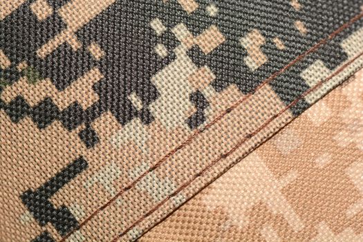 close up of worn out olive green tone camouflage fabric