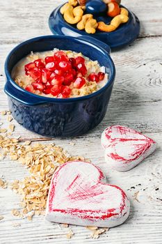 Blue pot of porridge decorated with pomegranate seeds