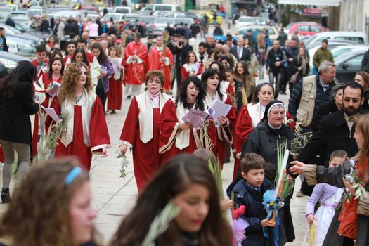 WEST BANK, Bethlehem: Palestinian Catholics walk to the Church of the Nativity Compound, to celebrate the Palm Sunday on March 20, 2016 in the West Bank city of Bethlehem. Palm Sunday marks the triumphant return of Jesus Christ to Jerusalem when a cheering crowd greeted him waving palm leaves, a week before his crucifixion.
