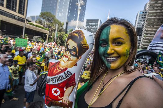 BRAZIL, Sao Paulo: A woman holds a balloon representing President Dilma Rousseff as thousands of protesters demonstrate against Brazilian former president (2003-2011) Luiz Inacio Lula da Silva in Sao Paulo, on March 20, 2016. Brazilian lawmakers relaunched impeachment proceedings against President Dilma Rousseff Thursday and a judge blocked her bid to bring her powerful predecessor into her cabinet, intensifying the political crisis engulfing her.