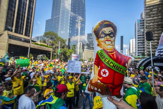BRAZIL, Sao Paulo: A demonstrator holds a balloon representing President Dilma Rousseff as thousands of protesters demonstrate against Brazilian former president (2003-2011) Luiz Inacio Lula da Silva in Sao Paulo, on March 20, 2016. Brazilian lawmakers relaunched impeachment proceedings against President Dilma Rousseff Thursday and a judge blocked her bid to bring her powerful predecessor into her cabinet, intensifying the political crisis engulfing her.
