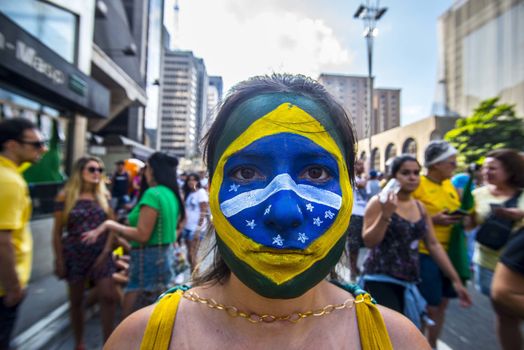BRAZIL, Sao Paulo: A woman with the Brazilian national flags painted on her face poses as thousands of protesters demonstrate against Brazilian former president (2003-2011) Luiz Inacio Lula da Silva in Sao Paulo, on March 20, 2016. Brazilian lawmakers relaunched impeachment proceedings against President Dilma Rousseff Thursday and a judge blocked her bid to bring her powerful predecessor into her cabinet, intensifying the political crisis engulfing her.