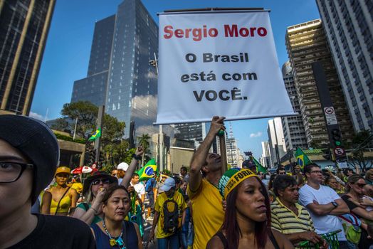 BRAZIL, Sao Paulo: A man holds a placard which reads 'Sergio Moro (judge): Brazil stands with you' as thousands of protesters demonstrate against Brazilian former president (2003-2011) Luiz Inacio Lula da Silva in Sao Paulo, on March 20, 2016. Brazilian lawmakers relaunched impeachment proceedings against President Dilma Rousseff Thursday and a judge blocked her bid to bring her powerful predecessor into her cabinet, intensifying the political crisis engulfing her.