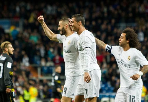 SPAIN, Madrid: Real Madrid's French Karim Benzema raises his fist (L) to celebrate victory during Spanish Liga football match Real Madrid vs Sevilla at Santiago Bernabeu stadium in Madrid on March 20, 2016.