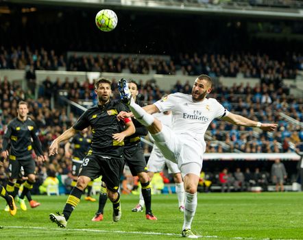 SPAIN, Madrid: Real Madrid's French Karim Benzema (R) in action during Spanish Liga football match Real Madrid vs Sevilla at Santiago Bernabeu stadium in Madrid on March 20, 2016.