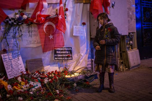 TURKEY, Istanbul: A girl drops off a flower on the site of a blast on Istiklal Street, a major shopping and tourist district, in central Istanbul on March 20, 2016, to pay tribute to four people killed during a suicide blast that ripped through Istanbul less than a week after another deadly attack left 35 dead in Ankara.
