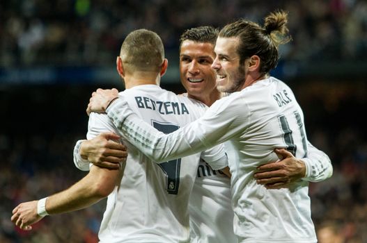 SPAIN, Madrid : Real Madrid's Welsh forward Gareth Bale (R), Real Madrid's French forward Karim Benzema (L) and Real Madrid's Portuguese forward Cristiano Ronaldo (C) celebrate scoring during the Spanish league football match Real Madrid CF vs Sevilla FC at the Santiago Bernabeu stadium in Madrid on March 20, 2016. 