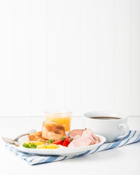 Ham and Eggs sunny side up served with coffee and orange juice.