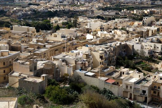 View of Victoria city in Malta, with historical limestone buildings.