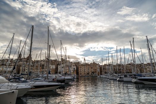 VALLETTA, MALTA - NPVEMBER 2, 2015 : View of Valletta marina with sailing boats, yatches and ships around, on cloudy sky background.