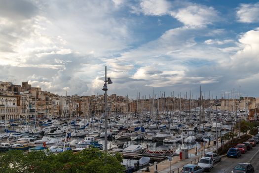 VALLETTA, MALTA - NPVEMBER 2, 2015 : View of Valletta marina with sailing boats, yatches and ships around, on cloudy sky background.