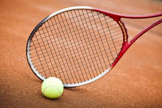 tennis background with tennis equipment on clay course