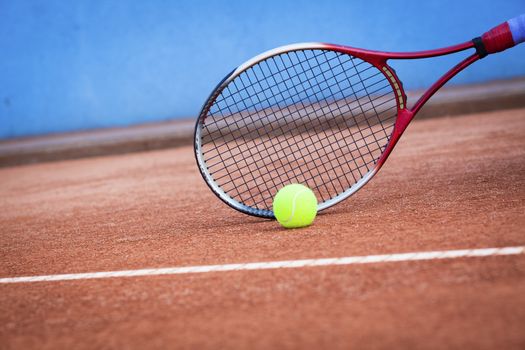 tennis background with tennis equipment on clay course