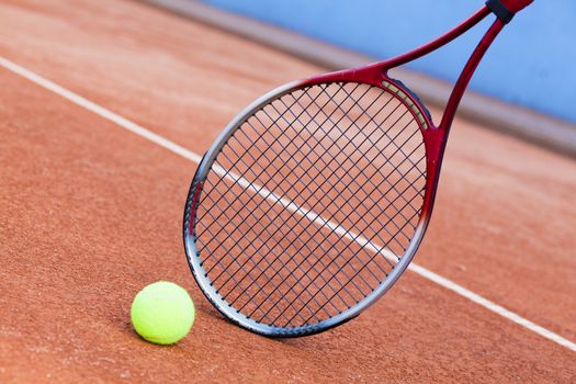 tennis background with tennis equipment on clay course