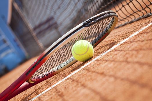 tennis background with tennis equipment on clay course