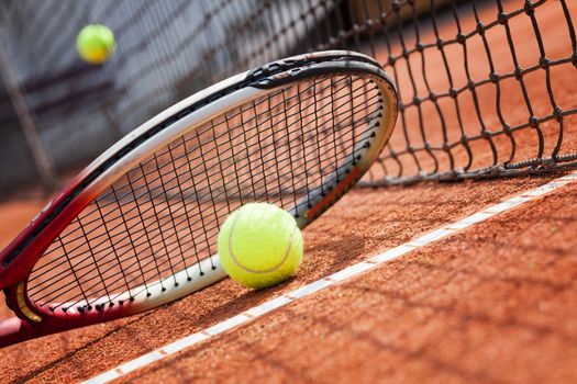 tennis background with tennis equipment on clay course