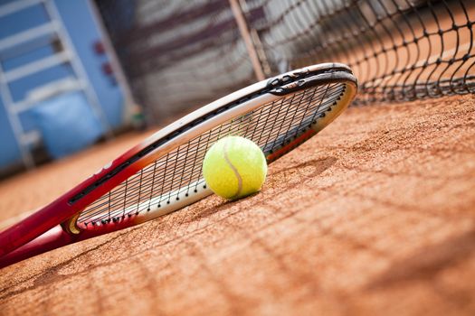 tennis background with tennis equipment on clay course