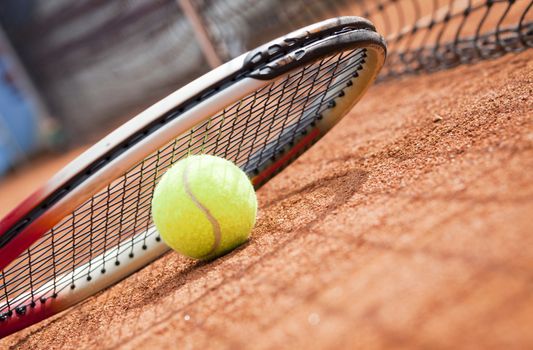 tennis background with tennis equipment on clay course