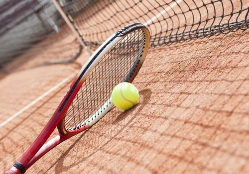 tennis background with tennis equipment on clay course