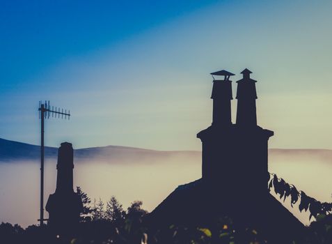 Rural Rooftop And Chimney Against Misty Dusk With Copy Space