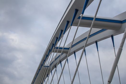 Apollo bridge in Bratislava, Slovakia, uniting banks of river Danube. Details of the construction. Intense clouds on the sky.