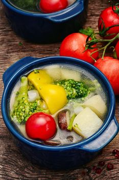 Tasty vegetable soup with peppers,potatoes,tomato,mushrooms and cauliflower
