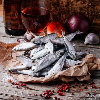 Glass of beer,smoked sprat,spices in traditional  rustic style 