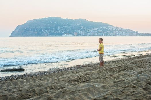 Kid boy walking at Alania beach, Turkey