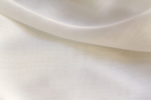 Shiny White silky fabric folds background texture