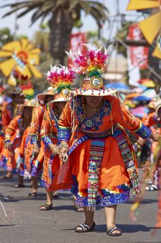 Tinku dancing group in colourful costumes performing a traditional ritual dance as part of the Carnaval Andino con la Fuerza del Sol in Arica, Chile.