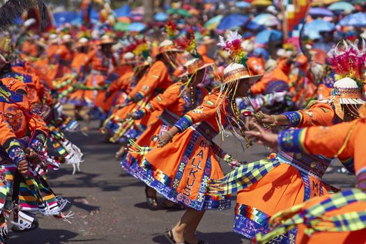 Tinku dancing group in colourful costumes performing a traditional ritual dance as part of the Carnaval Andino con la Fuerza del Sol in Arica, Chile.