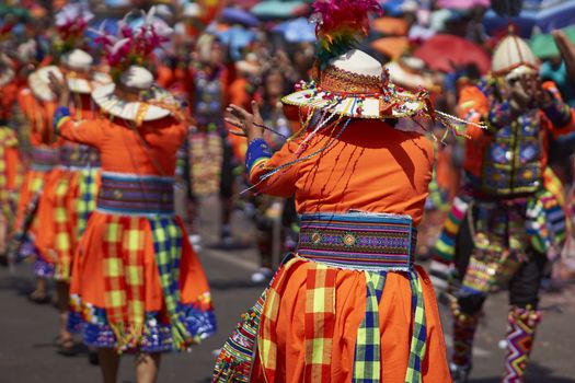 Tinku dancing group in colourful costumes performing a traditional ritual dance as part of the Carnaval Andino con la Fuerza del Sol in Arica, Chile.