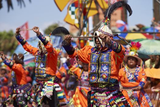 Tinku dancing group in colourful costumes performing a traditional ritual dance as part of the Carnaval Andino con la Fuerza del Sol in Arica, Chile.