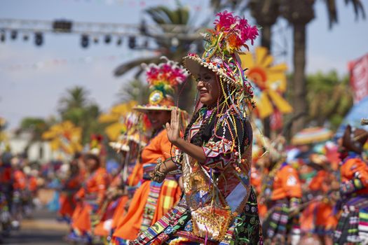 Tinku dancing group in colourful costumes performing a traditional ritual dance as part of the Carnaval Andino con la Fuerza del Sol in Arica, Chile.