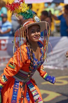 Tinku dancing group in colourful costumes performing a traditional ritual dance as part of the Carnaval Andino con la Fuerza del Sol in Arica, Chile.