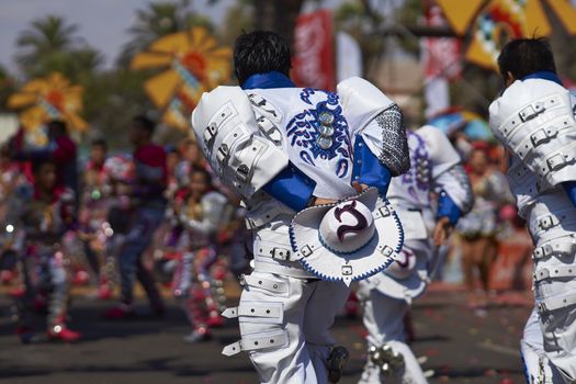 Caporales dancers in traditional Andean costume performing at the annual Carnaval Andino con la Fuerza del Sol in Arica, Chile.