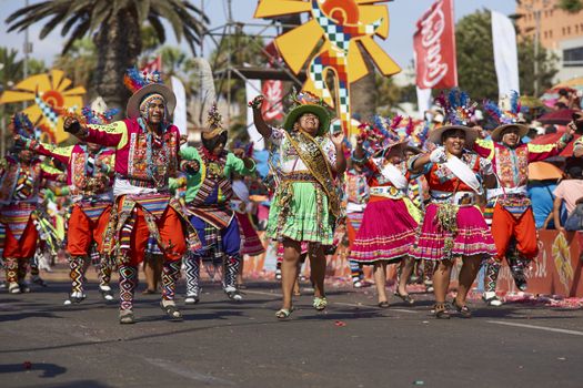 Tinku dancing group in colourful costumes performing a traditional ritual dance as part of the Carnaval Andino con la Fuerza del Sol in Arica, Chile.