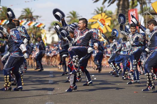 Caporales dance group in ornate costumes performing at the annual Carnaval Andino con la Fuerza del Sol in Arica, Chile.