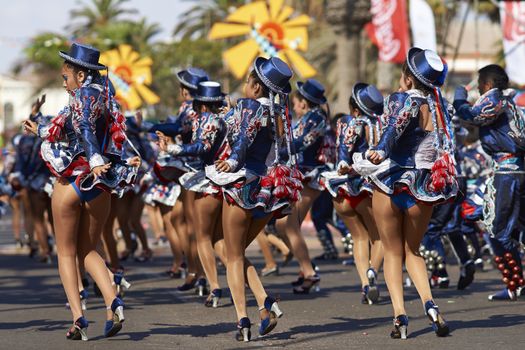Female members of a Caporales dance group in ornate costumes performing at the annual Carnaval Andino con la Fuerza del Sol in Arica, Chile.
