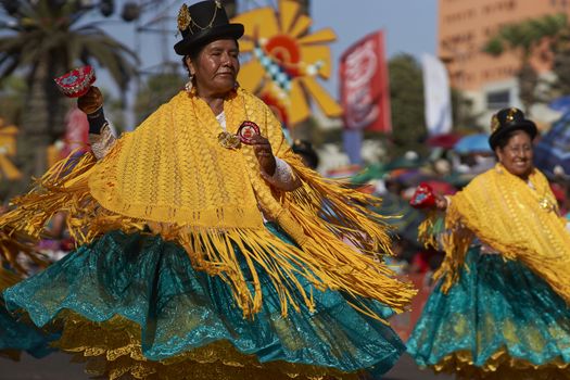 Morenada dancers in traditional Andean costume performing at the annual Carnaval Andino con la Fuerza del Sol in Arica, Chile.