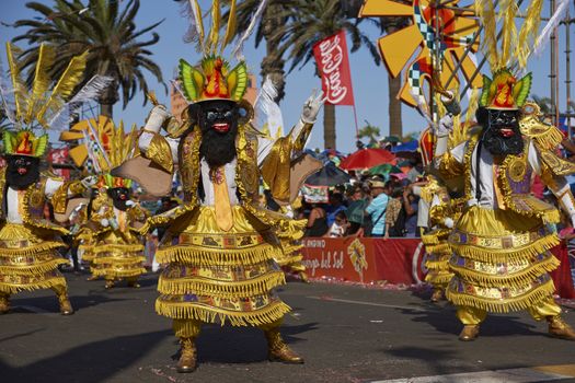 Morenada dancers in traditional Andean costume performing at the annual Carnaval Andino con la Fuerza del Sol in Arica, Chile.