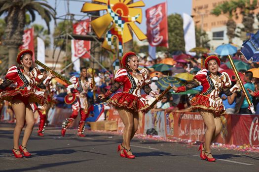 Caporales dancers in ornate costumes performing at the annual Carnaval Andino con la Fuerza del Sol in Arica, Chile.