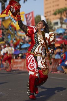 Caporales dancer in ornate costumes performing at the annual Carnaval Andino con la Fuerza del Sol in Arica, Chile.